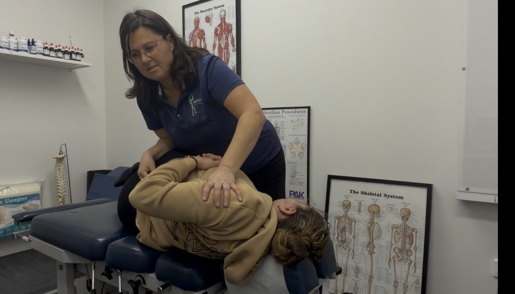 Gregory Hills Chiropractic adjusting someone's lower back after they've been sick