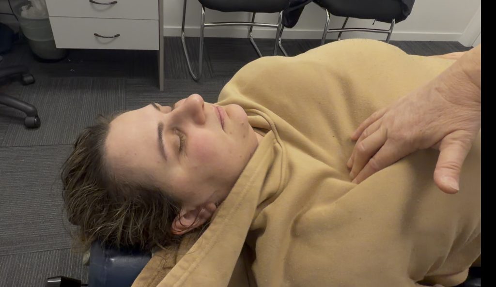 Gregory Hills Chiropractor working on someone's chest and ribs after they've been sick - coughing